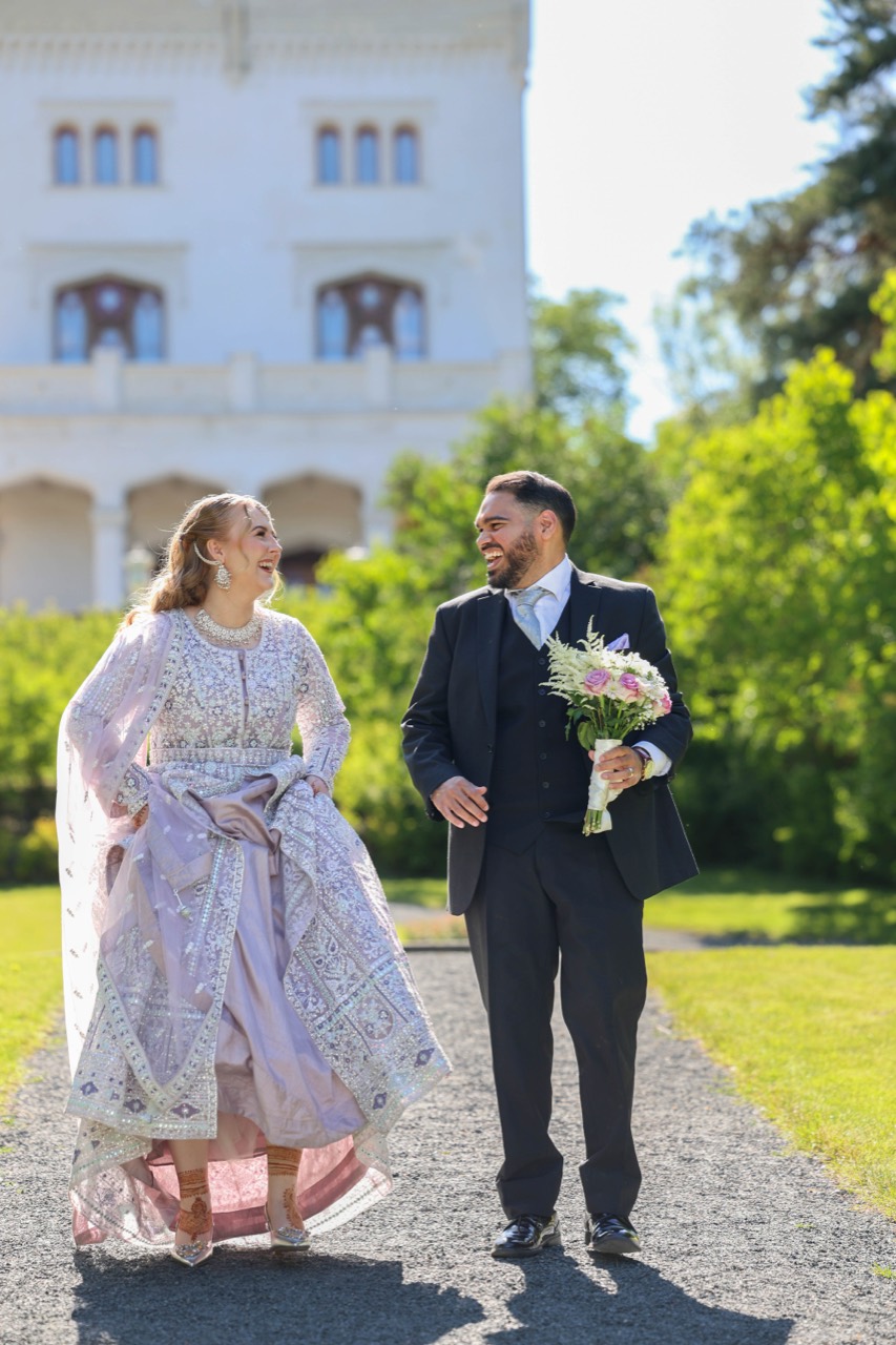 Bride and groom walking outdoors in a Mahaan Photography wedding portrait